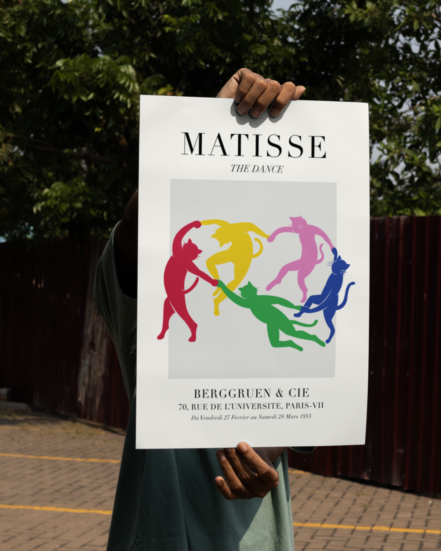Unframed Dance colorful cat print – Matisse-inspired abstract feline poster featuring five vibrant dancing cats, held outdoors